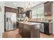 Modern kitchen features an island, stainless steel appliances, granite countertops, and pendant lighting at 3246 Spicy Cedar Ln, Lithonia, GA 30038