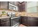 Modern kitchen featuring stainless steel appliances, granite countertops, and dark cabinets at 3246 Spicy Cedar Ln, Lithonia, GA 30038