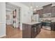 Modern kitchen with dark cabinets, granite countertops, stainless appliances, and a center island at 3246 Spicy Cedar Ln, Lithonia, GA 30038