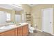 Bright bathroom featuring a double vanity, tiled floors, and decorative shelving at 401 Buckboard Ln, Locust Grove, GA 30248