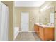 Bathroom featuring double vanity, tile flooring, and shower-tub combo at 401 Buckboard Ln, Locust Grove, GA 30248