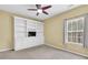 A bedroom featuring built-in shelves and an exterior window at 401 Buckboard Ln, Locust Grove, GA 30248