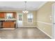 Dining area featuring neutral walls, a window, and open access to the kitchen at 401 Buckboard Ln, Locust Grove, GA 30248