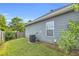 Exterior view of a well-maintained home with gray siding and a green yard at 401 Buckboard Ln, Locust Grove, GA 30248