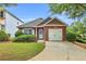 Charming single-story brick home with a well-manicured lawn and attached one-car garage at 401 Buckboard Ln, Locust Grove, GA 30248