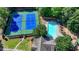 An aerial view shows community tennis courts and a pool with ample chairs for residents at 5965 Vista Brook Dr, Suwanee, GA 30024