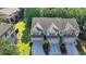Aerial view of a townhome with a gray roof and two-car garage with landscaping in front at 5965 Vista Brook Dr, Suwanee, GA 30024
