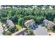Aerial view of the gray roof of townhome, surrounded by green trees and grass at 5965 Vista Brook Dr, Suwanee, GA 30024