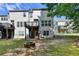 A backyard with green grass, a stone fire pit, and the exterior of the home at 5965 Vista Brook Dr, Suwanee, GA 30024