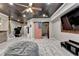 Finished basement with a ceiling fan, entertainment center, and a unique American flag barn door at 5965 Vista Brook Dr, Suwanee, GA 30024