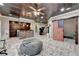 Open basement with a wet bar, stone accents, home gym, and an American flag barn door at 5965 Vista Brook Dr, Suwanee, GA 30024