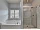 Bright bathroom with a soaking tub and walk-in shower at 5965 Vista Brook Dr, Suwanee, GA 30024