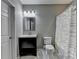 This bathroom has a gray wall, a mirror over the sink, and a striped shower curtain at 5965 Vista Brook Dr, Suwanee, GA 30024