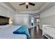 Spacious bedroom featuring a tray ceiling, ceiling fan, and wood floors at 5965 Vista Brook Dr, Suwanee, GA 30024