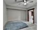 Bedroom with light-colored flooring, a ceiling fan, and a wood-trimmed doorway at 5965 Vista Brook Dr, Suwanee, GA 30024