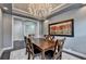 Open-concept dining room featuring a wooden table, chandelier, and doorway leading to other rooms in the home at 5965 Vista Brook Dr, Suwanee, GA 30024