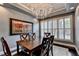 Chic dining room with a wooden table, a vibrant art piece, and white shuttered windows that provide ample natural light at 5965 Vista Brook Dr, Suwanee, GA 30024