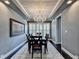 Elegant dining room featuring a decorative chandelier, wood-paneled ceiling, and dark hardwood floors and neutral wall color at 5965 Vista Brook Dr, Suwanee, GA 30024