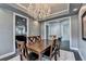 Elegant dining area with a chandelier, views into the kitchen, and classic decor enhancing its cozy atmosphere at 5965 Vista Brook Dr, Suwanee, GA 30024