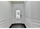 Bright entryway with white trim, gray walls, and a door with glass panels allowing natural light to illuminate the space at 5965 Vista Brook Dr, Suwanee, GA 30024