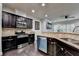Modern kitchen featuring stainless steel appliances and dark wood cabinetry at 5965 Vista Brook Dr, Suwanee, GA 30024