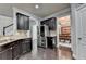 Stylish kitchen with stainless appliances, dark cabinets, and adjacent dining area at 5965 Vista Brook Dr, Suwanee, GA 30024