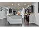 Modern kitchen featuring dark cabinets, granite countertops, and an open design that flows into the dining and living areas at 5965 Vista Brook Dr, Suwanee, GA 30024