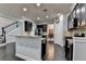 Modern kitchen with dark cabinetry, granite countertops, and stainless steel appliances, seamlessly connected to the dining area at 5965 Vista Brook Dr, Suwanee, GA 30024