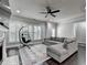 Comfortable living room with fireplace, ceiling fan, and large windows at 5965 Vista Brook Dr, Suwanee, GA 30024