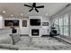 Inviting living room featuring a fireplace, ceiling fan, and modern decor at 5965 Vista Brook Dr, Suwanee, GA 30024
