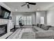 Spacious living room with fireplace, ceiling fan, and lots of natural light at 5965 Vista Brook Dr, Suwanee, GA 30024