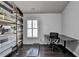 Home office with a treadmill, built-in shelving, and modern desk setup at 5965 Vista Brook Dr, Suwanee, GA 30024