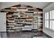 Home office with a treadmill, built-in shelving, and accent wall at 5965 Vista Brook Dr, Suwanee, GA 30024