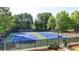 A view of the community tennis courts surrounded by mature trees at 5965 Vista Brook Dr, Suwanee, GA 30024