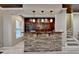Basement wet bar with stone accents, wood backsplash, pendant lighting, and counter seating at 5965 Vista Brook Dr, Suwanee, GA 30024
