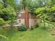 Aerial view of the home nestled among mature trees on a large lot with green grass at 1103 Lee Ne Cir, Atlanta, GA 30324
