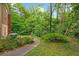 A secluded backyard bordered by lush greenery and mature trees providing privacy at 1103 Lee Ne Cir, Atlanta, GA 30324