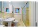 Vintage bathroom featuring tiled walls, pedestal sink, stained-glass window, and glass-enclosed shower at 1103 Lee Ne Cir, Atlanta, GA 30324