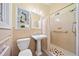 Cozy bathroom with pedestal sink, shower, and decorative shelving above the toilet at 1103 Lee Ne Cir, Atlanta, GA 30324