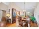 Dining room with hardwood floors, a chandelier, and a view into the kitchen and living areas at 1103 Lee Ne Cir, Atlanta, GA 30324
