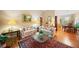 Inviting living room featuring a classic rug, comfortable seating, and views into the adjacent dining area at 1103 Lee Ne Cir, Atlanta, GA 30324