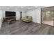 Finished basement features wood flooring, a large TV, and furniture at 3711 Frey Lake Nw Rd, Kennesaw, GA 30144
