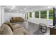 Finished basement with neutral decor, wood flooring, and large windows at 3711 Frey Lake Nw Rd, Kennesaw, GA 30144