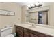 Well-lit bathroom with wood vanity, ample counter space, and toilet at 3711 Frey Lake Nw Rd, Kennesaw, GA 30144