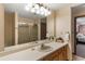 Neutral bathroom with walk-in shower, light countertops, and wooden cabinets at 3711 Frey Lake Nw Rd, Kennesaw, GA 30144