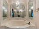 Opulent bathroom showcasing an intricate mirror design and a large soaking tub at 3711 Frey Lake Nw Rd, Kennesaw, GA 30144