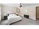 Comfortable bedroom featuring neutral carpet, ceiling fan, and natural lighting at 3711 Frey Lake Nw Rd, Kennesaw, GA 30144