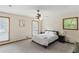 Bright bedroom featuring neutral carpet, ceiling fan, and two large windows at 3711 Frey Lake Nw Rd, Kennesaw, GA 30144