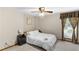 Cozy bedroom with large window, neutral carpet, and a ceiling fan at 3711 Frey Lake Nw Rd, Kennesaw, GA 30144