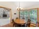 Bright dining room with wood table and chairs, large window, and view of fireplace at 3711 Frey Lake Nw Rd, Kennesaw, GA 30144